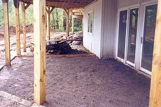 Residential property before landscaping with sparse vegetation and bare ground