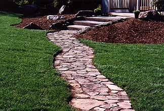 Flagstone path set in a bed of ground cover plants