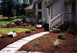 Side pathway with retaining wall and landscape lighting