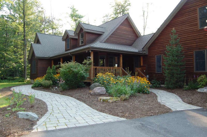 Natural stone walkway winding through a lush garden bed