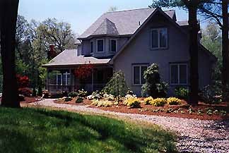 Woodland-edge property with native plantings and boulders