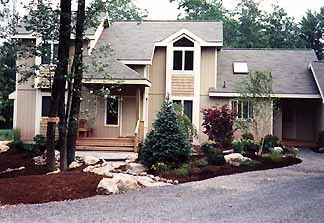 Manicured lawn bordered by layered perennial beds
