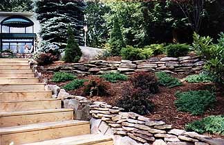 Lakefront property with tiered landscape beds stepping down to the water
